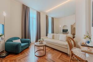 a living room with a couch and a chair at Lolli Palace Hotel in Sanremo