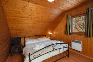 a bedroom with a bed in a wooden cabin at Chata Zuzana in Terchová