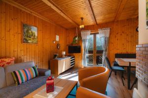 a living room with a couch and a table at Chata Zuzana in Terchová