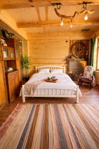 a bedroom with a white bed in a wooden room at Alashkert Guesthouse Premium and Cozy Studios in Gyumri in Gyumri