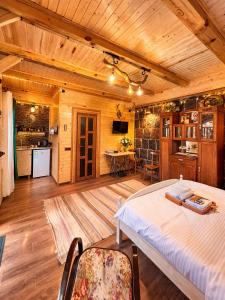 a bedroom with a large bed and a kitchen at Alashkert Guesthouse Premium and Cozy Studios in Gyumri in Gyumri
