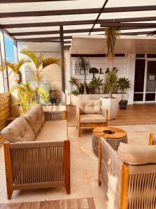 a living room with couches and tables and plants at Hotel Binder Quality Inn in Mogi das Cruzes