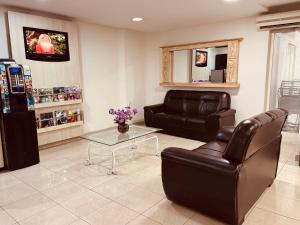a living room with a couch and a coffee table at Hotel Binder Quality Inn in Mogi das Cruzes