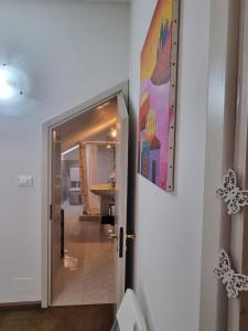 a hallway leading to a bathroom with a painting on the wall at Breve Sosta in Santhià