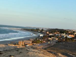 a view of a beach with a town and the ocean at Casa Tartaruga Emboaca Trairí in Trairi