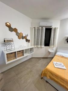 a bedroom with a bed and white walls at Casa Anna in Costa Rei