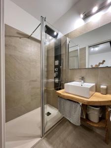 a bathroom with a sink and a shower at Casa Anna in Costa Rei +5 photos