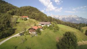 an aerial view of a house on a grassy hill at Lehnhäusl Aschauer in Berchtesgaden