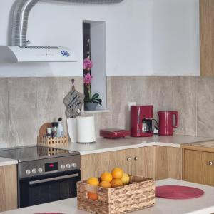 a kitchen with a basket of oranges on the counter at Sea View apartment in Gythio