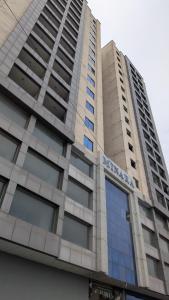 a tall building with a sign on top of it at Dreamland royal suite in Rawalpindi