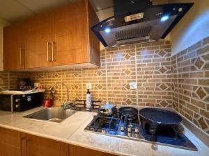 a kitchen with a stove top and a sink at Dreamland royal suite in Rawalpindi