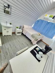 a small bedroom with a bed and a sink in a tent at Paulos View Lodge in Colonia