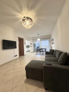 a living room with a couch and a chandelier at Torre Sole Fiumara in Genoa