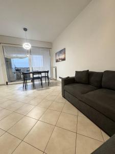 a living room with a couch and a table at Torre Sole Fiumara in Genoa