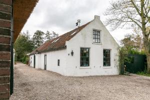 a white building with a window on the side of it at BoHo Experience Wellness, Jacuzzi, Sauna, BBQ, Garden, Sleeps 10 in Kockengen