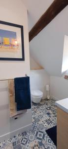 a bathroom with a toilet and blue towels at Retour en Baie in Pendé +23 photos