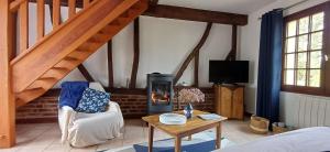 a living room with a wood stove in a room at Retour en Baie in Pendé