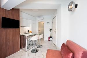 a kitchen and living room with a couch and a counter at Downtown Skyloft in Kalamata