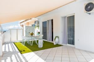 a balcony with a table and chairs at Downtown Skyloft in Kalamata