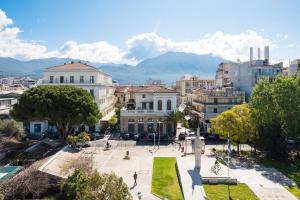 a view of a city with mountains in the background at Downtown Skyloft in Kalamata