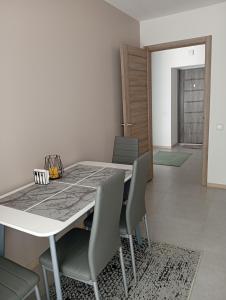 a dining room with a white table and chairs at Dolce Vita in Ternopil