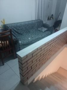 a couch sitting in a living room next to a table at Mikel rooms in Peshkopi