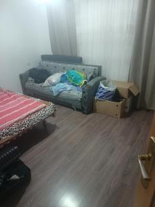 a room with a couch and boxes on the floor at Mikel rooms in Peshkopi
