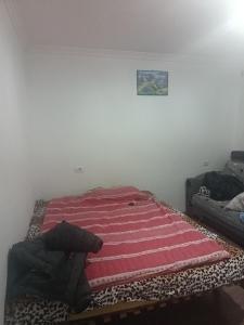 a bed sitting in a corner of a room at Mikel rooms in Peshkopi