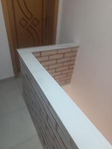 a room with a brick wall and a door at Mikel rooms in Peshkopi