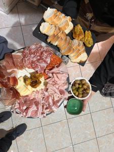 a table full of different types of meats and bread at King of the road in Ceprano