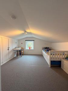 a bedroom with a bed and a desk in it at Wohlfühlbude Fehmarn in Fehmarn