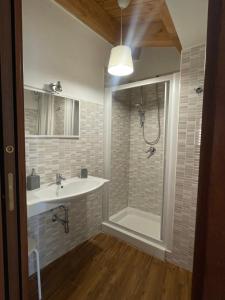 a bathroom with a sink and a shower at La Pietra Gialla in Pietrapertosa +10 photos