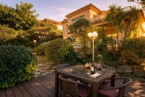 a table with glasses of wine on a patio at Cabril's Hills - Stunning Villa with Pool & Sea Views in Cabrils