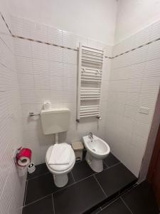a small bathroom with a toilet and a sink at Dolce Casa in Ferrara