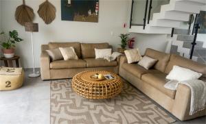 a living room with two couches and a table at Dolphin View Beach House in Walvis Bay +84 photos
