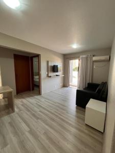 a living room with a couch and a table at Aquarius Flat 510 in Santa Cruz do Sul +5 photos