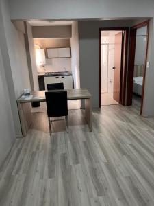 a kitchen and dining room with a table and chair at Aquarius Flat 510 in Santa Cruz do Sul