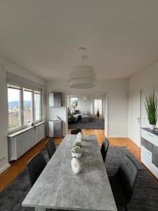 a living room with a large table and chairs at Wunderschönes Haus am Waldrand für max 8 Personen in Harztor