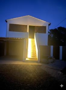 a white house with a staircase in front of it at Hot Room Sainte Victoire in Trets