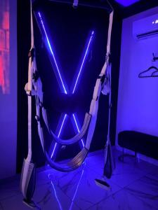 a motorcycle seat in a room with blue lights at Hot Room Sainte Victoire in Trets