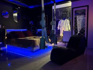 a bedroom with a bed in a room with a clothes rack at Hot Room Sainte Victoire in Trets +10 photos