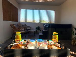 a table with a tray of bread and other food at Hot Room Sainte Victoire in Trets