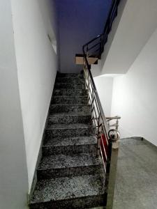 a stairway in a building with a staircase at Hotel Swami in Gogameri +1 photo
