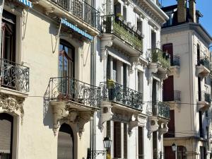 a building with balconies on the side of it at La Loge AL'AIX in Aix-les-Bains