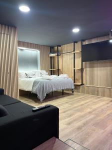 a bedroom with a bed and a tv in it at Nómada Orzán bajo in A Coruña