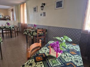 a restaurant with a table with purple flowers on it at Cote de France in Fundura +59 photos