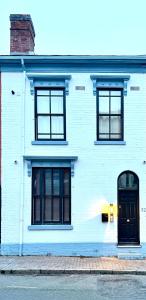 a white building with black windows and a black door at Hylton House in Birmingham
