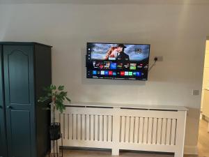 a flat screen tv hanging on a wall at The C & A Studio in Killala +4 photos