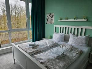 a bedroom with two beds in front of a window at Apartment am Steinweg in Emden