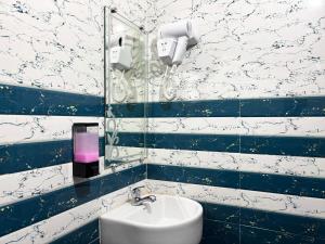 a blue and white bathroom with a sink and a phone at Hotel Radha Rani palace in Ayodhya +57 photos